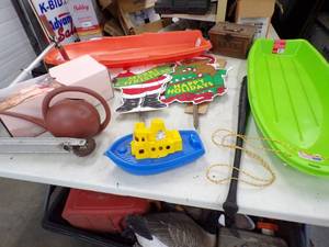 lot 10 image: Pair of Sleds, Christmas Yard Dcor, Scooter, watering can, and flower dcor