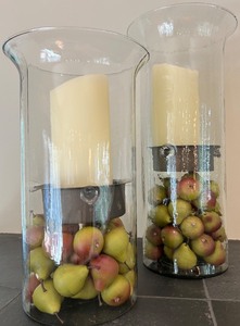 lot 117 image: Pair of Decorative Glass Hurricanes with Faux Fruit and Candles
