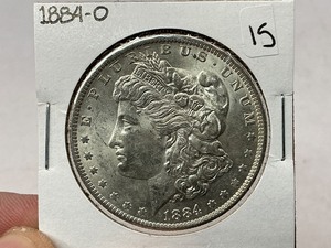 lot 15 image: 1884-O Morgan Silver Dollar