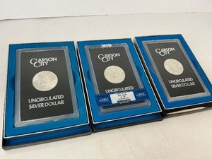 lot 69 image: Three Mint State GSA CC Morgan Silver Dollars