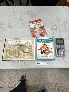 lot 145 image: HUNTING BOOK, FISH BOOK, TI-84 PLUS CALCULATOR & THE HEROS JOURNAL