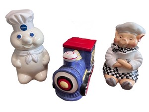 lot 100 image: Set of 3 Ceramic Kitchen Collectibles - Pillsbury Doughboy, Train, and Chef Pig