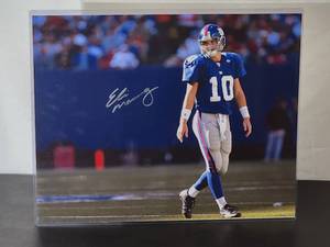 lot 22 image: Autographed Photo by New York Giants Great Quarterback Eli Manning No COA