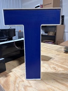lot 25 image: Blue Front Lit Channel Letter T Illuminated Sinage