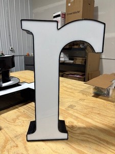 lot 26 image: White Front Lit Channel Letter R Illuminated Sinage