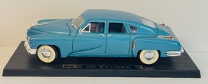 lot 310 image: 1948 Blue Tucker Torpedo Diecast Car in 124 Scale Model with Base Road Legends