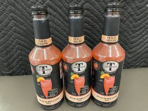 lot 28 image: Set of 3 Mr & Mrs T Peach Bellini Mix Bottles