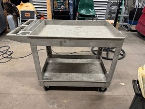 lot 75 image: Rubbermaid Cart. 45 (to handle) x 26 x 33.  Rolls Well.