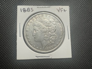 lot 39 image: 1885 VF Morgan Dollar. Authentic patina with some mint luster remaining.