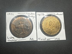 lot 85 image: (2) Older Even Tokens. Both in excellent condition. The 1958 Fosston Centennial is a tough find.