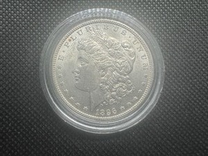 lot 88 image: 1896 Uncirculated Morgan Dollar. Full, flashy mint luster.  Significant but not distracting bagmarks in the field on the obverse, otherwise a great coin.