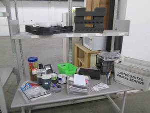 lot 149 image: Contents of shelf filled with office supplies