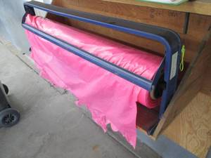 lot 132 image: Roll dispenser with roll of plastic film