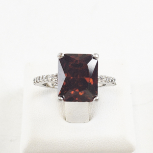 lot 54 image: Garnet and Cubic Zirconia Base Metal Ring. Size 6.75