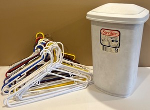 lot 96 image: Ironing Board with Sterilite Trash Can and Colorful Hangers Set