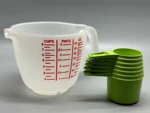 lot 142 image: Tupperware Measuring Set with Mixing Pitcher and Green Cups