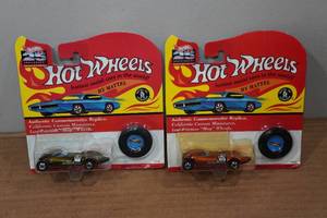 lot 34 image: 2 Hot Wheels Authentic Commemorative Replicas with Buttons
