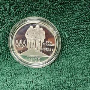 lot 8 image: 1995 Olympic 1 Oz Silver Round