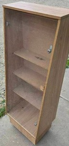 lot 228 image: Melamine display cabinet with clear plastic door, locks, 2 keys and 4 wheels