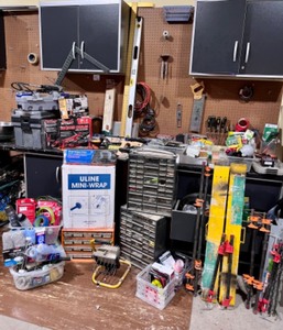 lot 189 image: Assorted Garage and Workshop Tool Collection with Clamps, Booster Cables, and Storage Bins