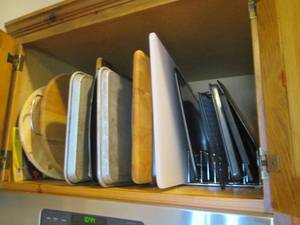 lot 150 image: Cupboard full of cutting boards, co...