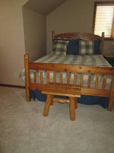 lot 1 image: Queen size log wood bed with beddin...