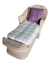 lot 9 image: Wicker Chaise Lounge with Plaid Cushion and Purple Pillow