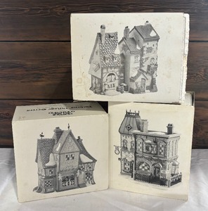 lot 37 image: Department 56 Village Buildings including Nettie Quinn Puppets & Marionettes, Fagins Hide-A-Way and Thomas Mudge Timepieces