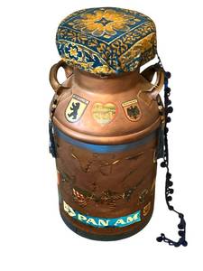 lot 54 image: Vintage Repurposed Milk Can Decorated with Travel Themed Stickers and Cushioned Chair Top (27 Tall)