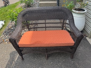 lot 219 image: Wicker Outdoor Patio Loveseat with Orange Cushion