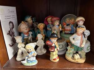 lot 144 image: Collection of Goebel Hummel Figurines with Display Stand