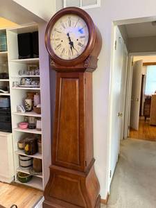lot 204 image: Beautiful Howard Miller 610-901 Grandfather Clock with Wood Case - Purple mark on clock face is due to lighting, not a flaw.