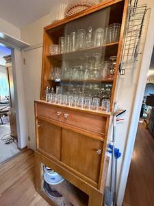 lot 240 image: Tall Wooden Hutch with Glass Doors and Storage Shelves