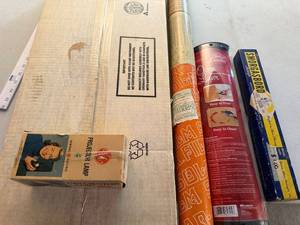 lot 307 image: Group of Vintage Household Items Including GE Projector Lamp, Solar-X Window Film, Oven Liner, and Smorgasbord Party Game