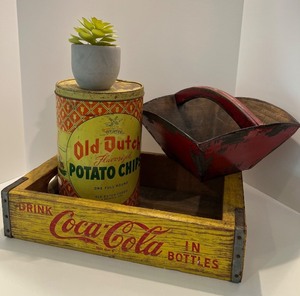 lot 85 image: Vintage Decor Lot with Coca-Cola Crate, Old Dutch Potato Chips Tin, Red Wooden Basket, and Faux Succulent