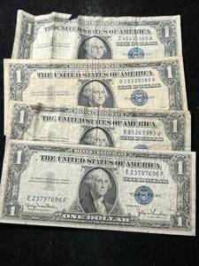lot 79 image: 4 US BLUE SEAL $1 SILVER CERTIFICATES