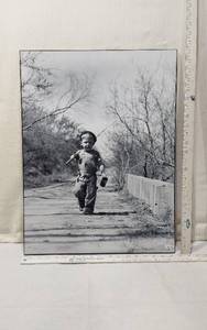 lot 20 image: Black and White Photograph of a Boy Walking Down a Country Lane with Fishing Pole Over His Shoulder - with Frame