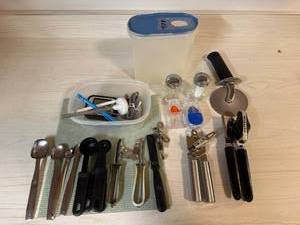 lot 273 image: Kitchen Utensil Assortment with Can Openers, Pizza Cutter, and Measuring Sets