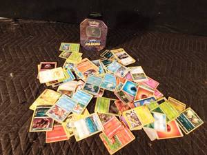 lot 124 image: Pokmon tin of 70 Pokmon trading cards