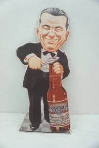 lot 13 image: Smiling Charlie Metal Budweiser Sign 13x30