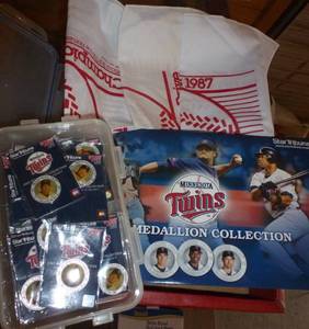lot 96 image: Twins memorabilia, bucket of baseballs, 2 bats