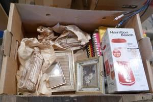 lot 270 image: Box of cookbooks, new hamilton beach blender, photo frames, dcor, hobnail wall lamp, clock, flag