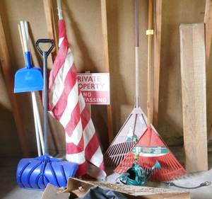 lot 291 image: Wall of rakes, brooms, shovel, flag