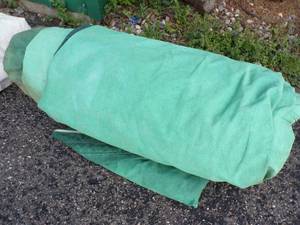 lot 63 image: Large Tarp may have holds or rips good for Wood Pile Green
