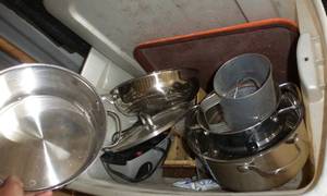 lot 49 image: tote full of kitchen stuff, 2 large pots, frying pan, colander, electric knife sharpener