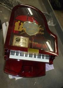lot 137 image: Piano music box, CD storage box, ice cream maker, small old pyrex dishes, sewing thread rack