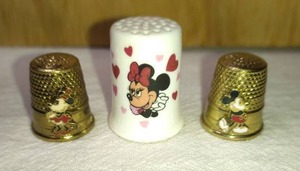 lot 180 image: Mickey and Minne Metal and Ceramic Minnie Thimbles