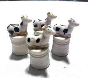 lot 20 image: Set of 4 Bisque Cow Thimbles