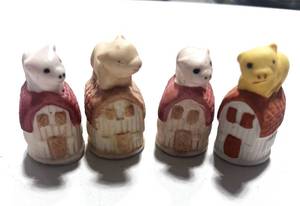 lot 21 image: Set of 4 Bisque Pig on Barn Thimbles
