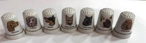 lot 31 image: Set of 7 Dog Themed Thimbles